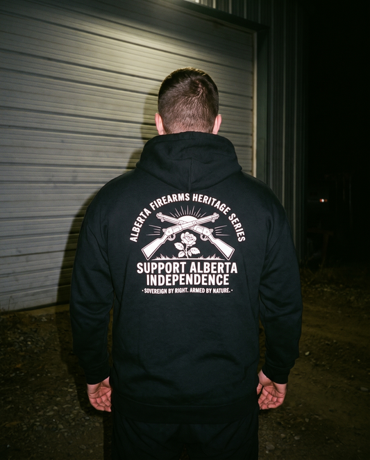 Man from behind wearing Firearm Heritage hoodie night flash photo industrial yard