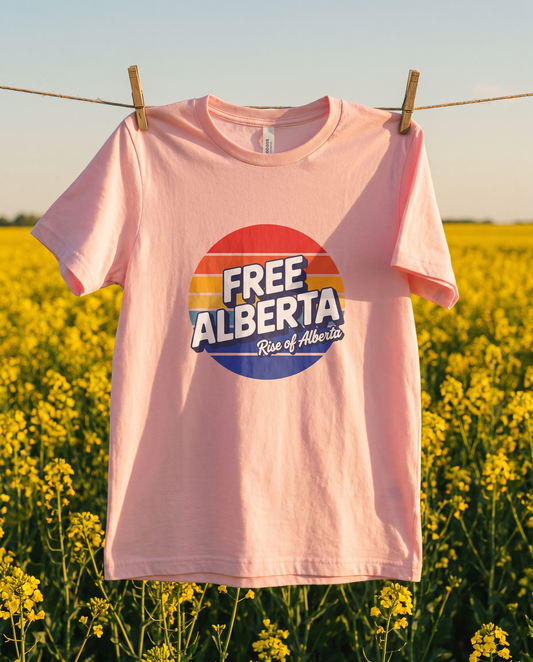Retro Free Alberta tee pink on clothesline against canola field