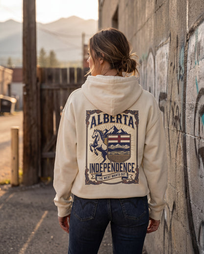 Person wearing a hoodie with 'Alberta Independence' design, standing against a graffiti-covered wall.