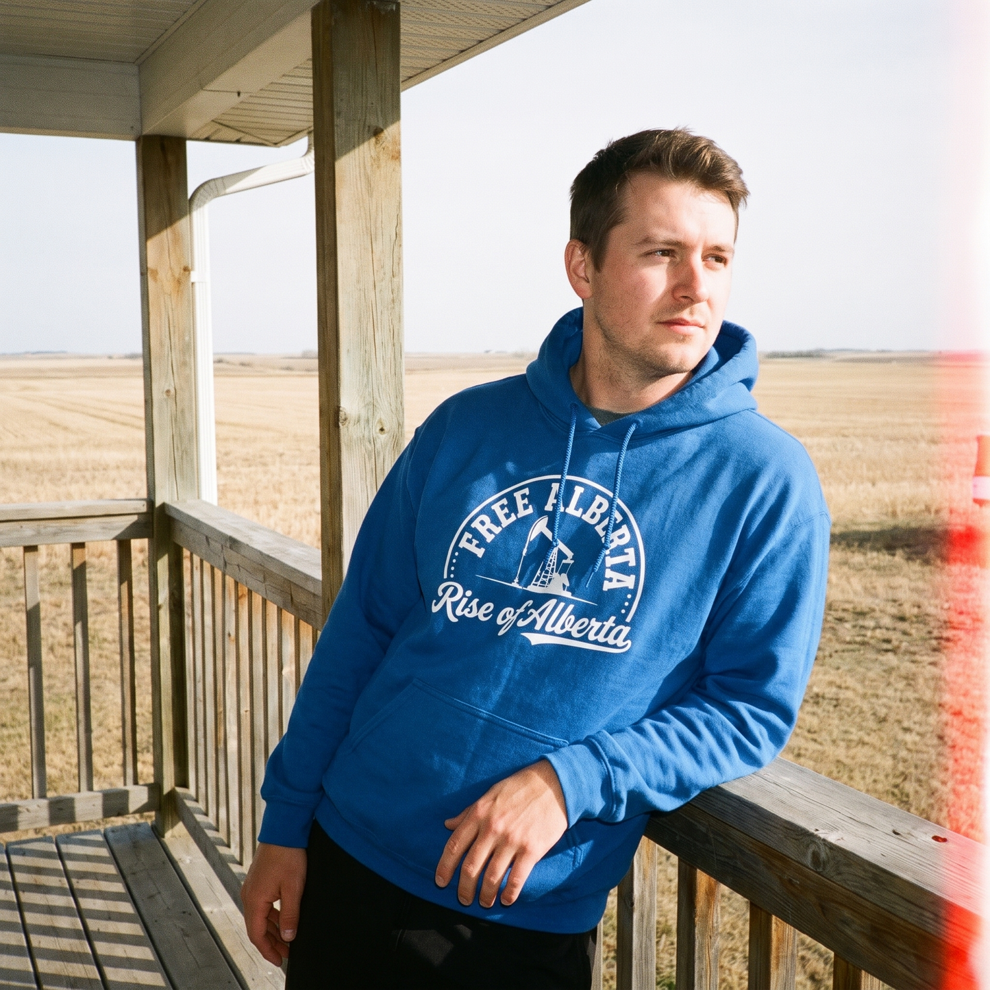 Free Alberta hoodie royal blue porch lifestyle