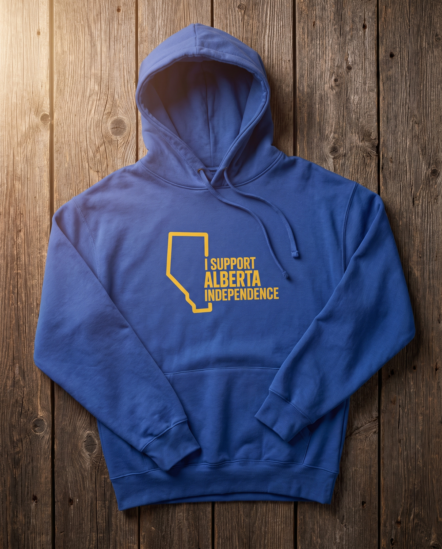 Support Alberta Independence cobalt oversized hoodie flat lay on barn wood