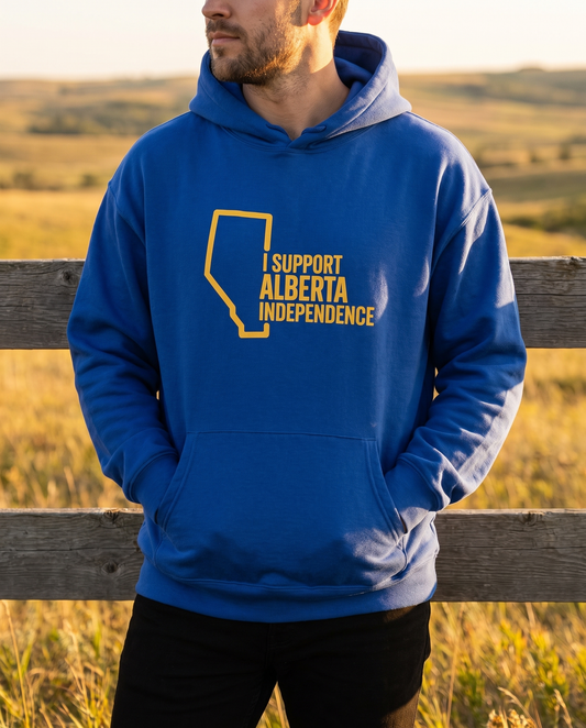 Man wearing cobalt Support Alberta Independence oversized hoodie at ranch fence golden hour