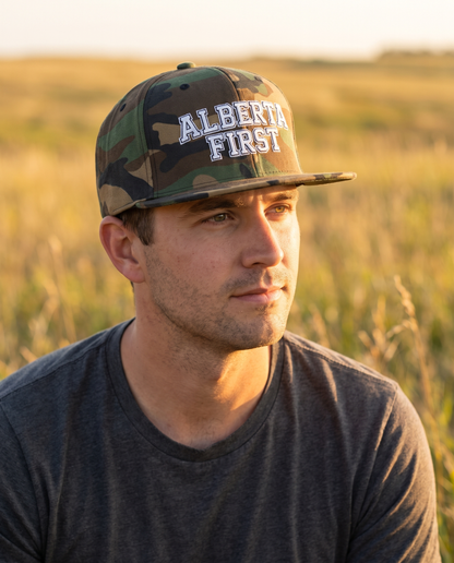 Man wearing Alberta First green camo snapback at golden hour