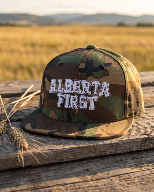 Alberta First embroidered green camo snapback hat on barn wood with prairie behind