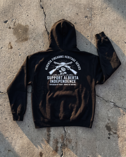 Firearm Heritage black hoodie back print flat lay on cracked concrete