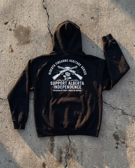 Firearm Heritage black hoodie back print flat lay on cracked concrete