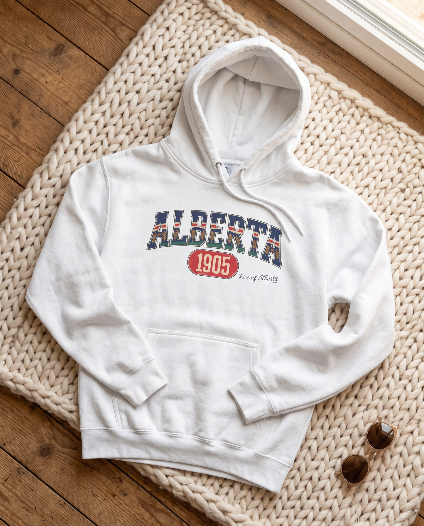 Alberta 1905 fleece hoodie white flat lay on knit blanket