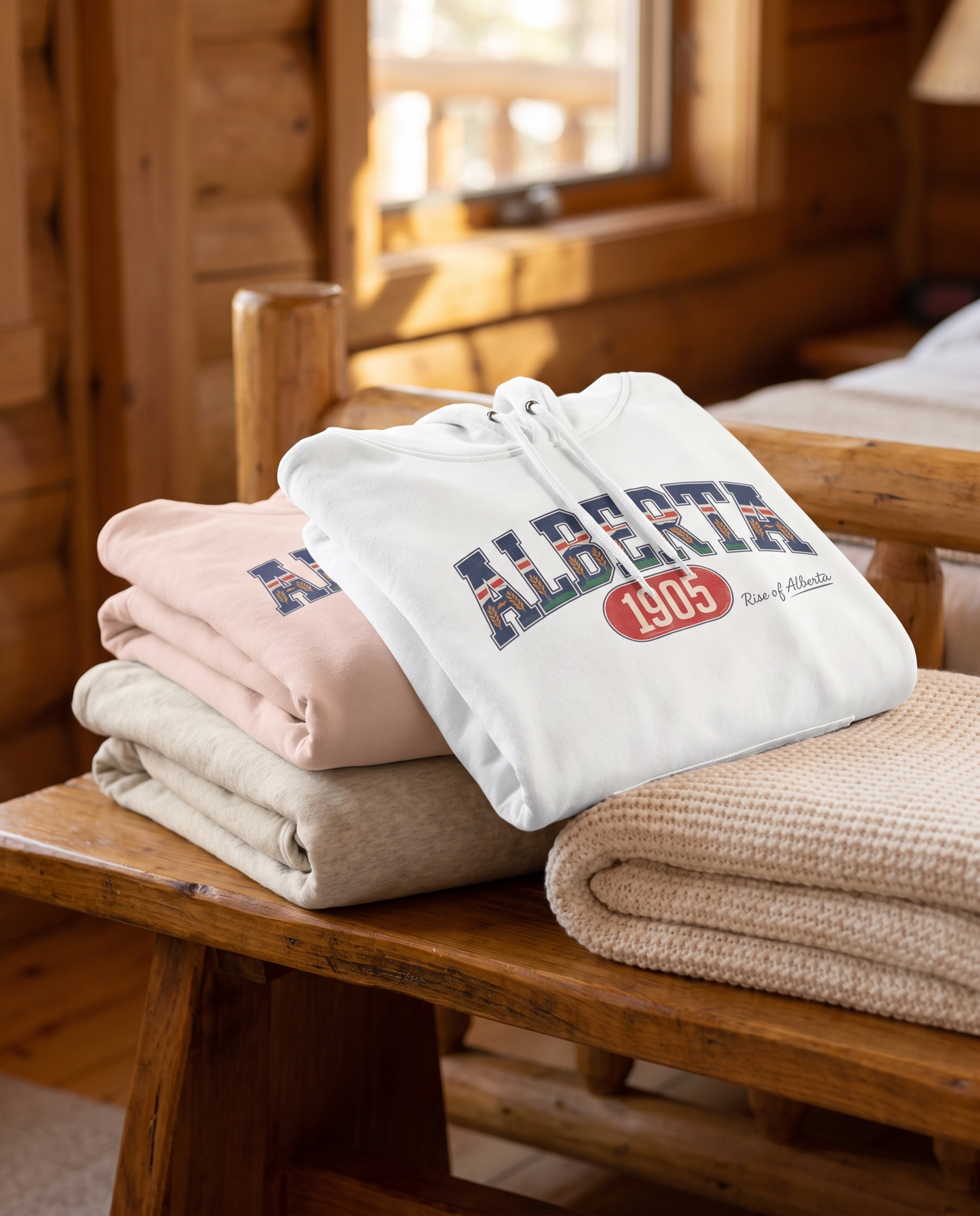 Alberta 1905 fleece hoodie all three colorways folded stack on wooden bench