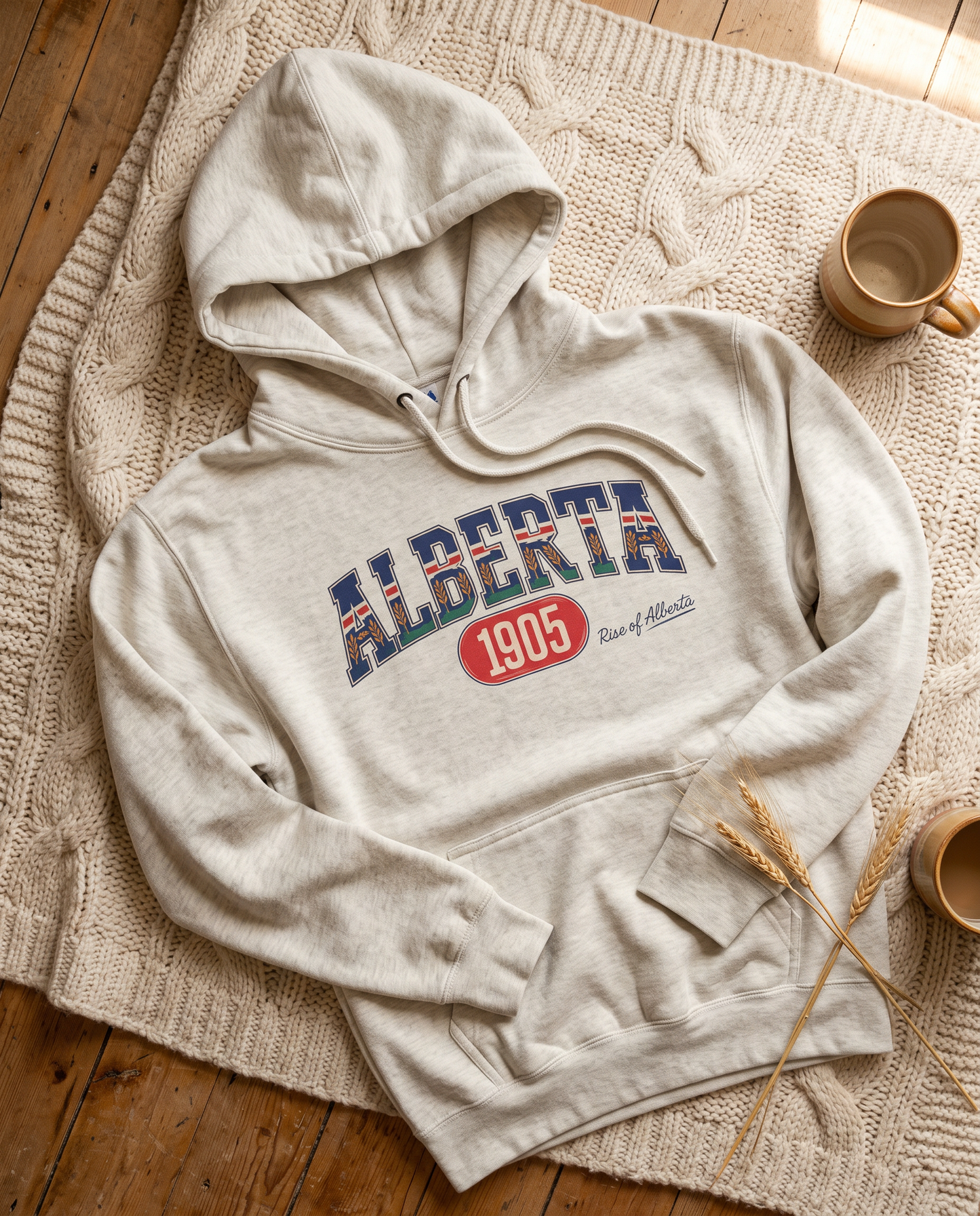 Alberta 1905 fleece hoodie oatmeal heather flat lay on knit blanket