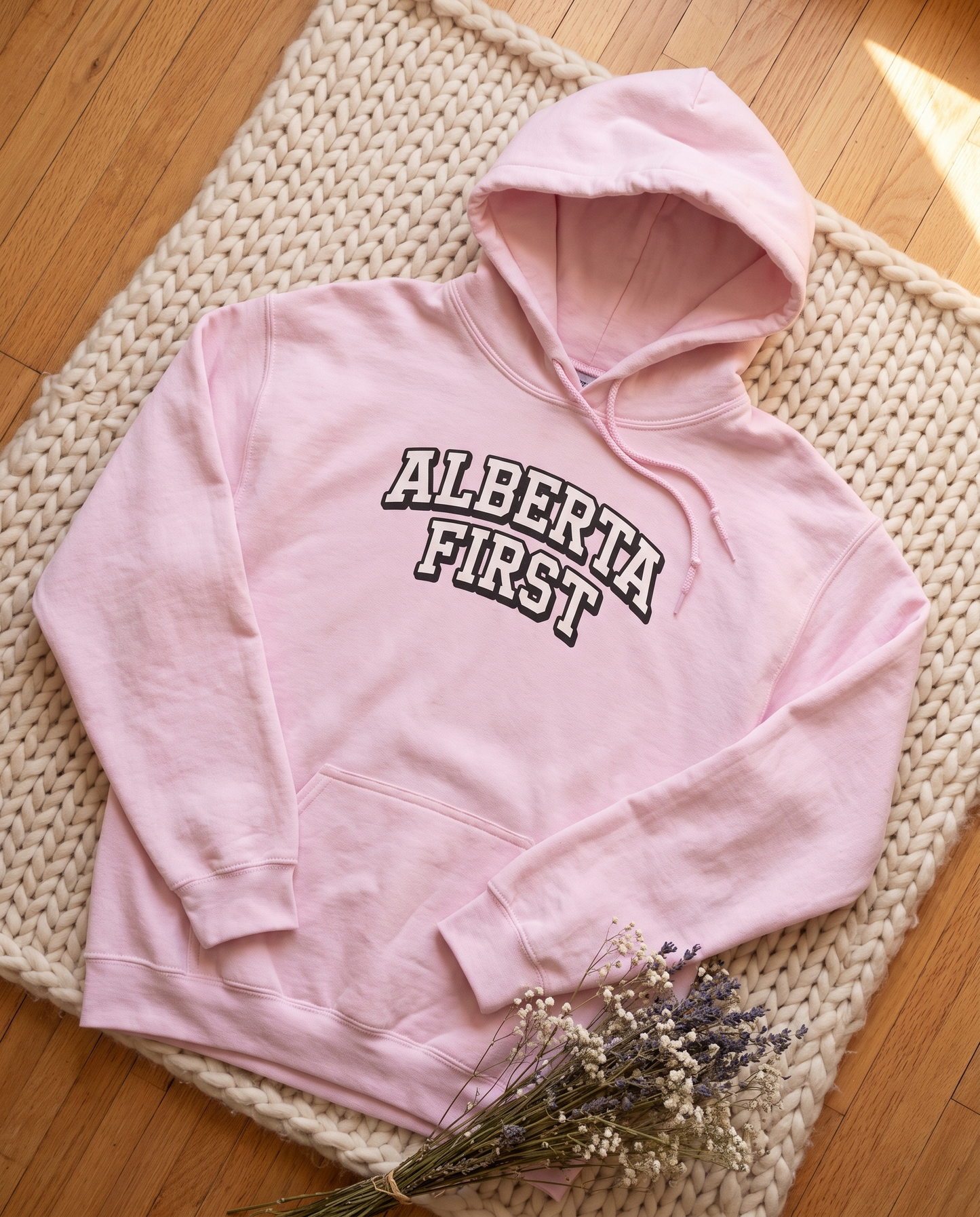 Womens Alberta First varsity hoodie light pink flat lay on knit blanket