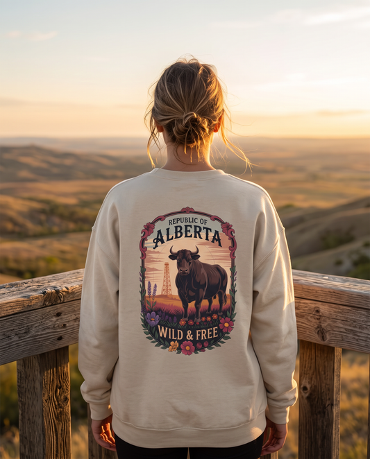 Woman from behind wearing sand Alberta Wild and Free crewneck at foothills lookout
