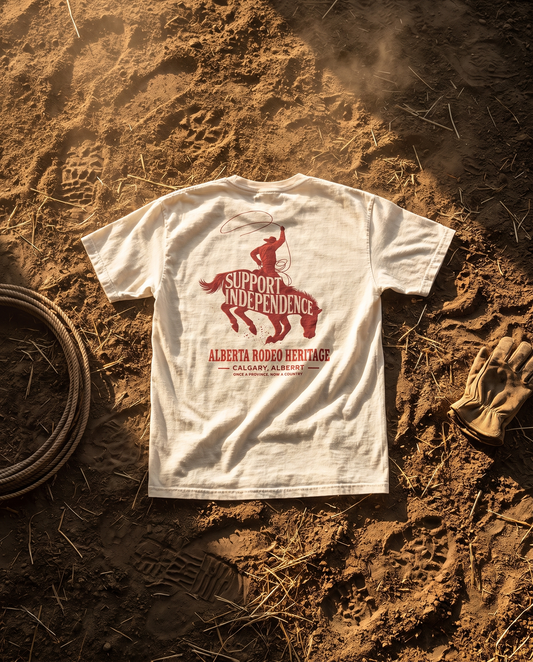 Stampede Rider Free Alberta tee ivory back print on rodeo arena dirt