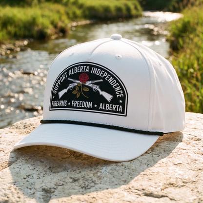 Alberta Firearms Freedom Rope Hat in white on a rock beside a creek
