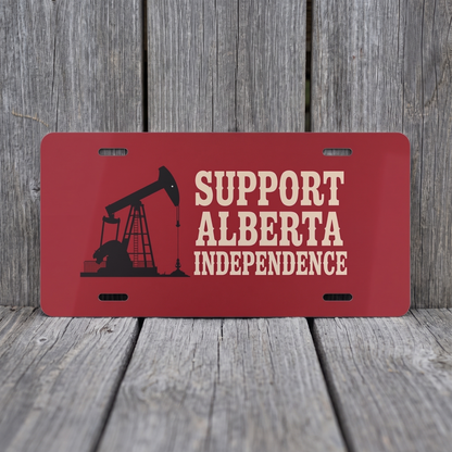 Alberta Independence Red vanity plate against weathered barn board