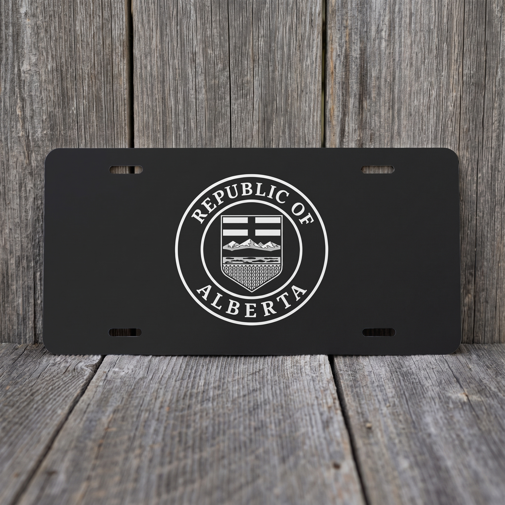 Black Republic of Alberta Seal vanity plate against weathered barn board