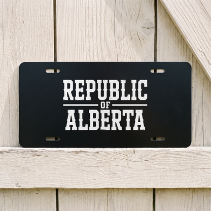 Black Republic of Alberta vanity plate against weathered barn board