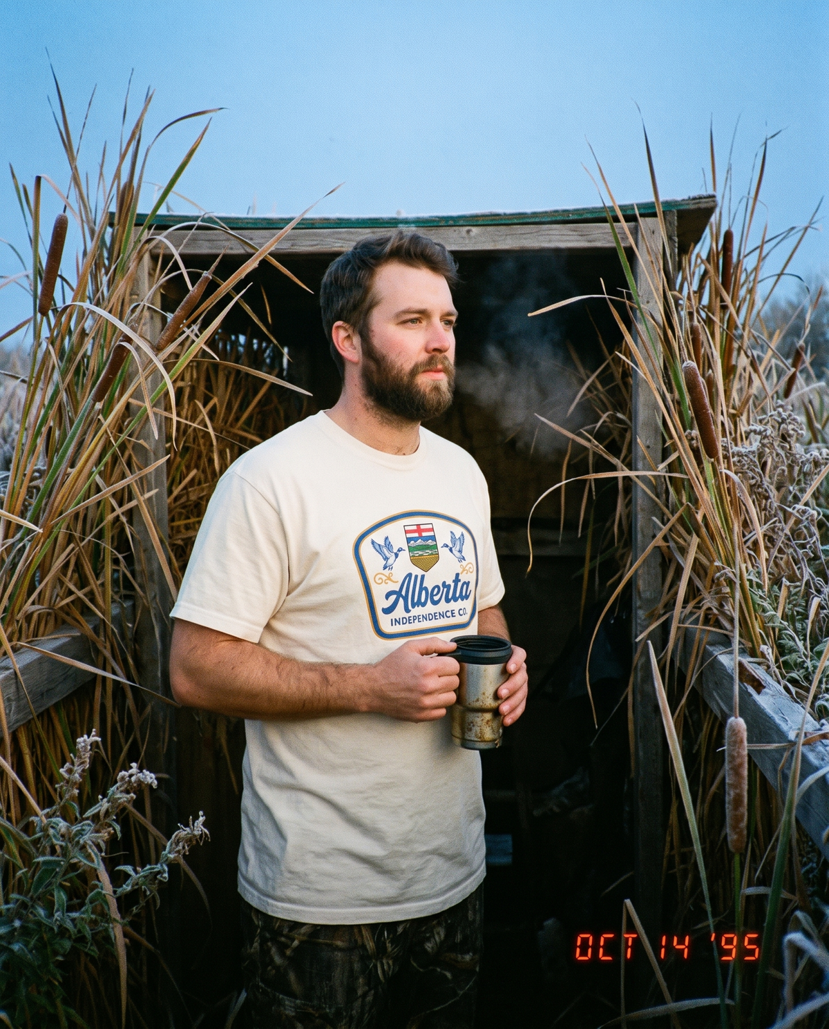 Heritage Tee in Ivory worn in a marsh at first light