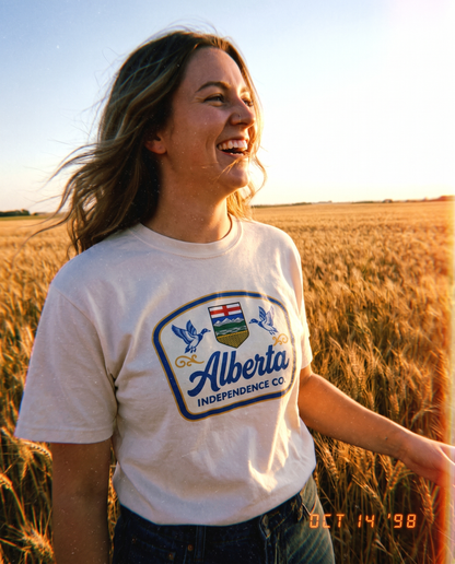 Heritage Tee in Ivory worn in an Alberta wheat field