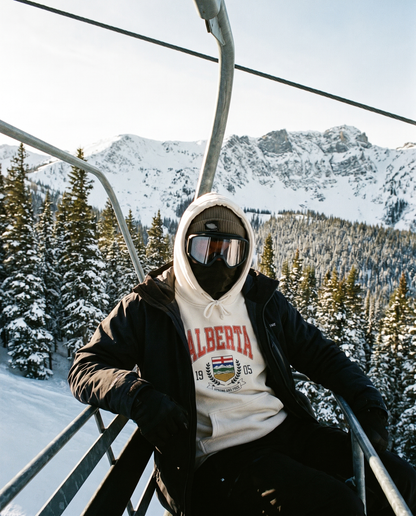 Alberta Coat of Arms Hoodie worn on a chairlift at an Alberta ski hill