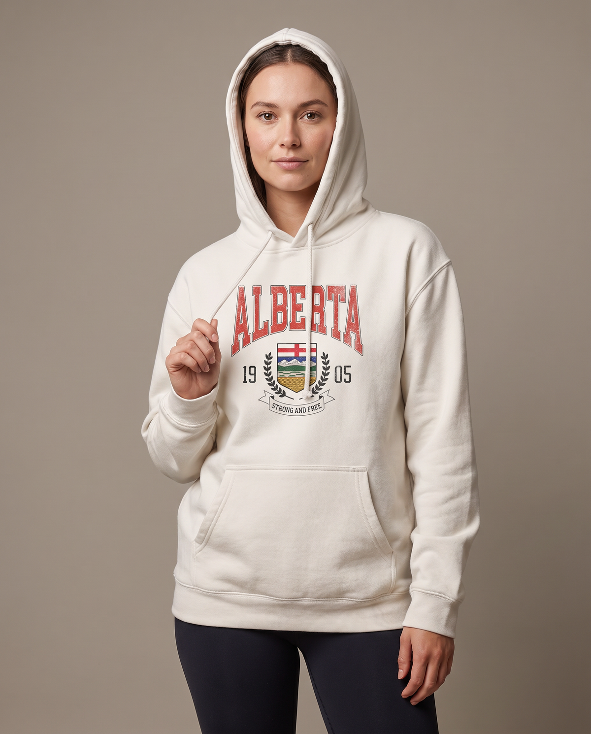 Woman wearing the Alberta Coat of Arms Hoodie oversized with the hood up