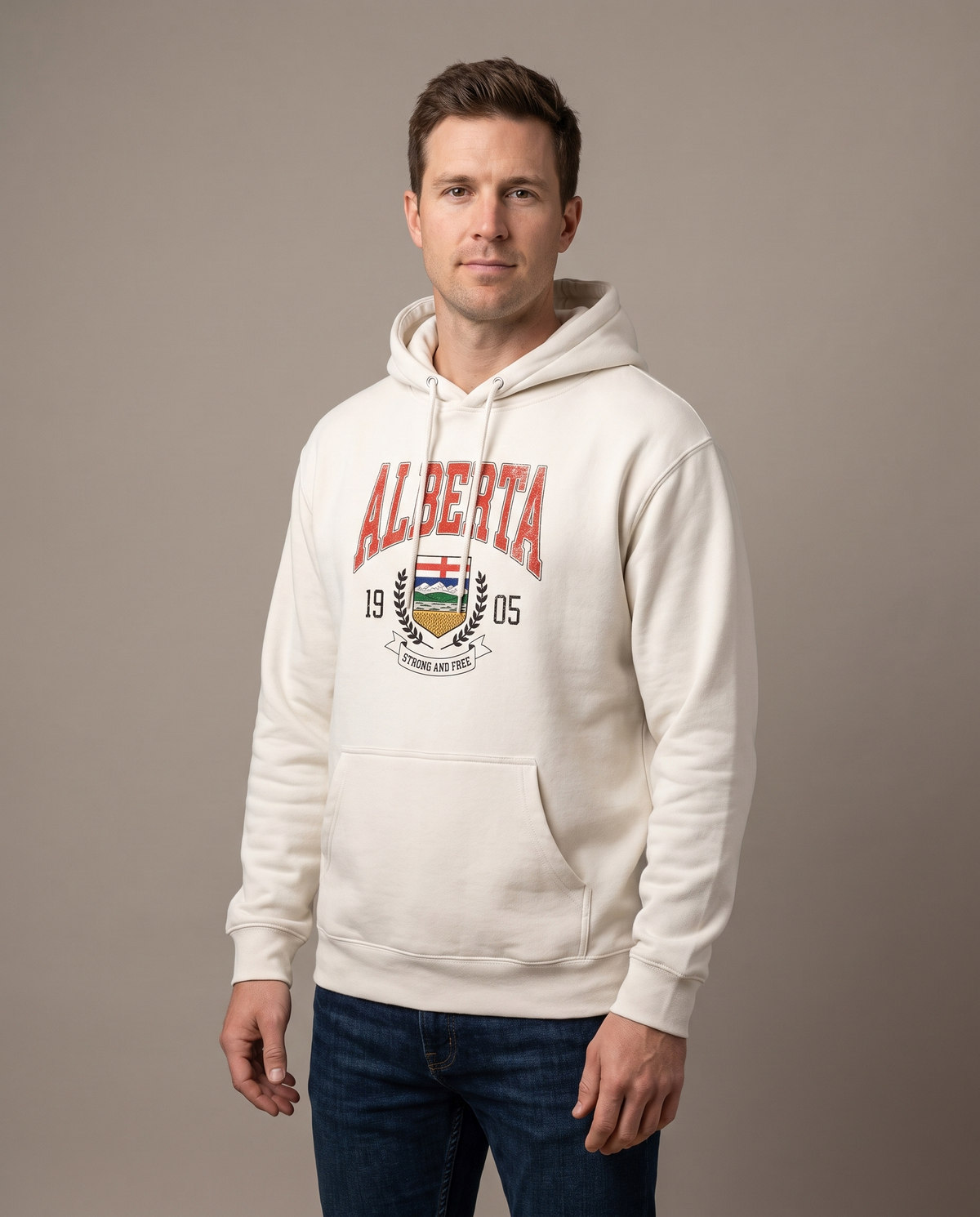 Man wearing the Alberta Coat of Arms Hoodie in bone cream