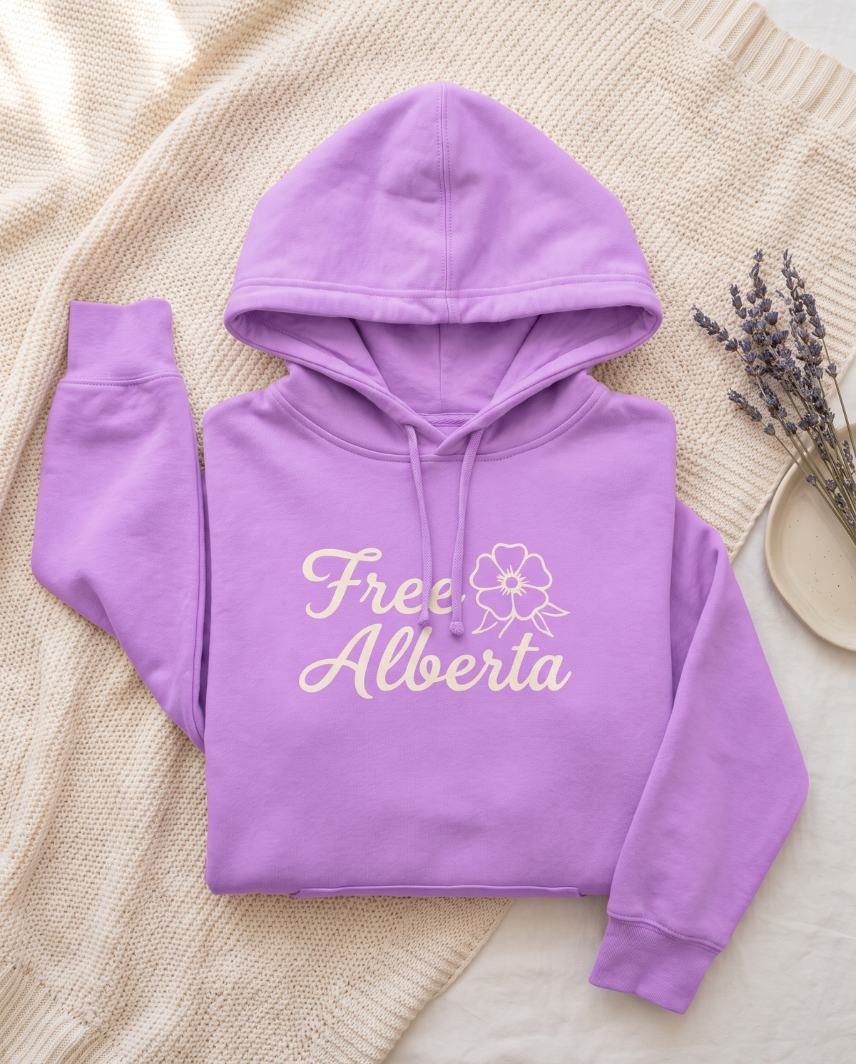 Free Alberta lightweight hoodie in Neon Violet flat lay on a knit blanket