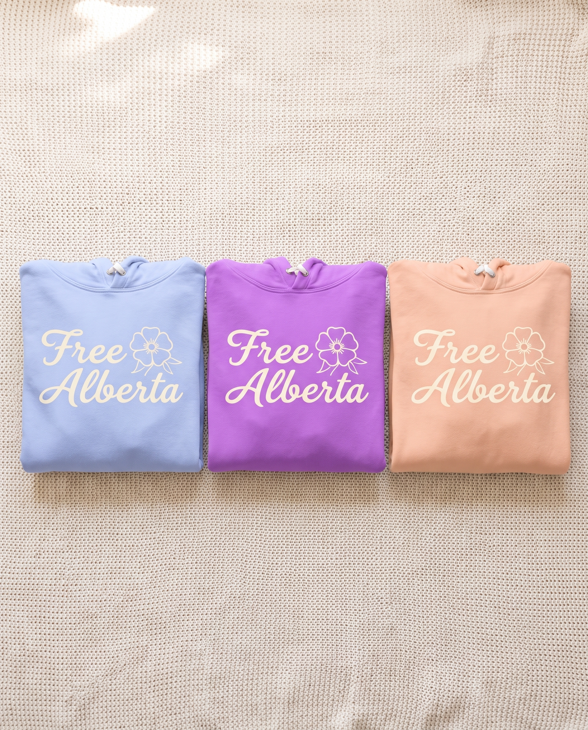 Free Alberta lightweight women's hoodie all three colourways folded together