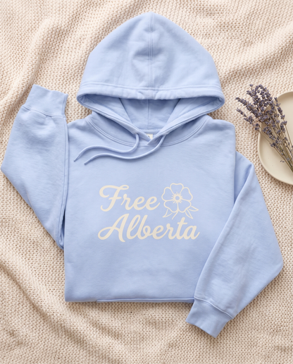 Free Alberta lightweight hoodie in Hydrangea blue flat lay on a knit blanket